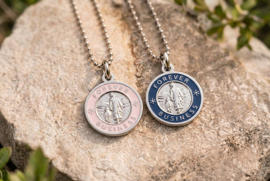 Two Forever Business necklaces resting on a rock